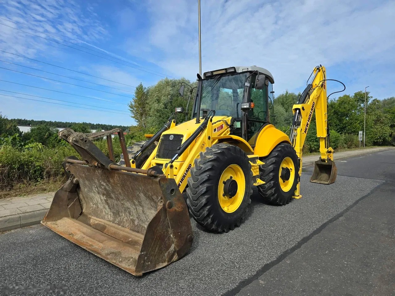 2009 New Holland B115B, 5 000 mth, dovoz Skladom v EÚ — foto 1 | AMECAR 2009 New Holland B115B, 5 000 mth, dovoz Skladom v EÚ — foto 1