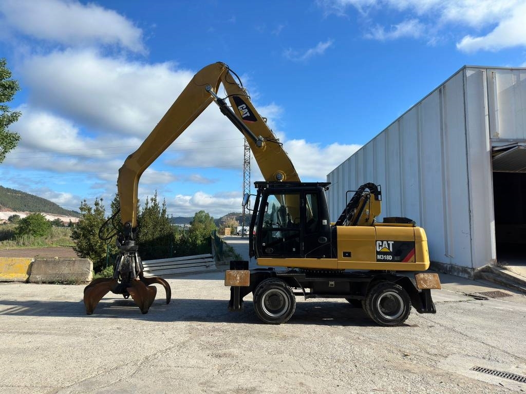 2014 Cat M 318 MH, 12 500 mth, dovoz Skladom v EÚ — foto 1